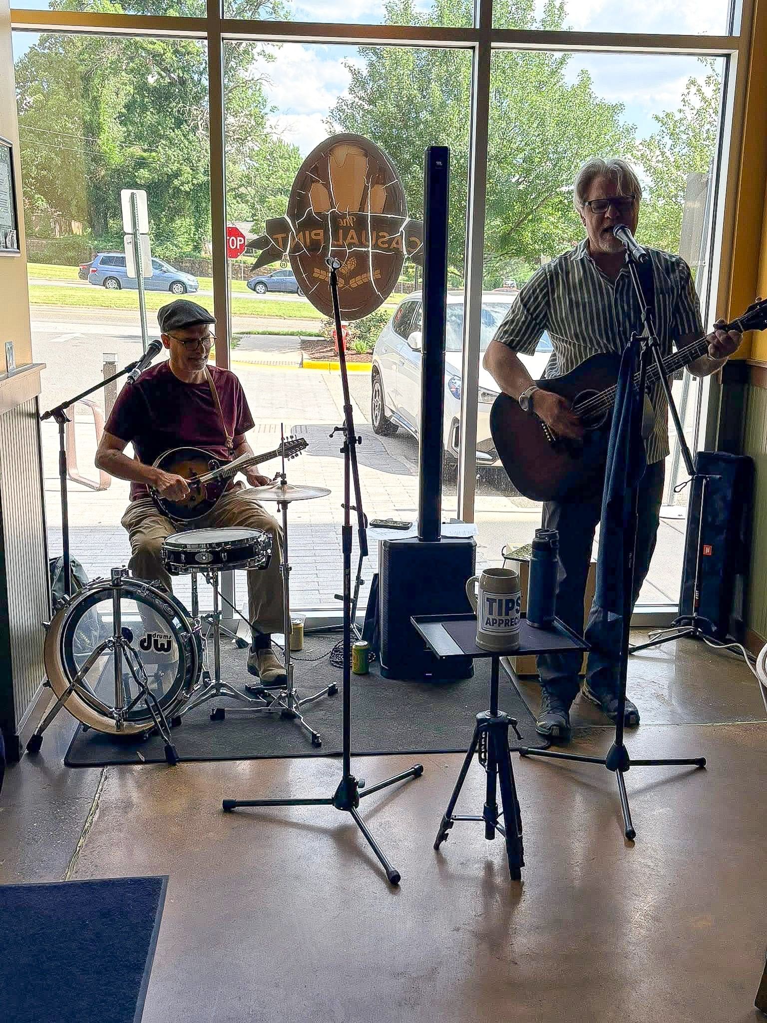 Patrick on drums and mandolin and Frank on guitar and vocals, playing in the window at The Casual Pint