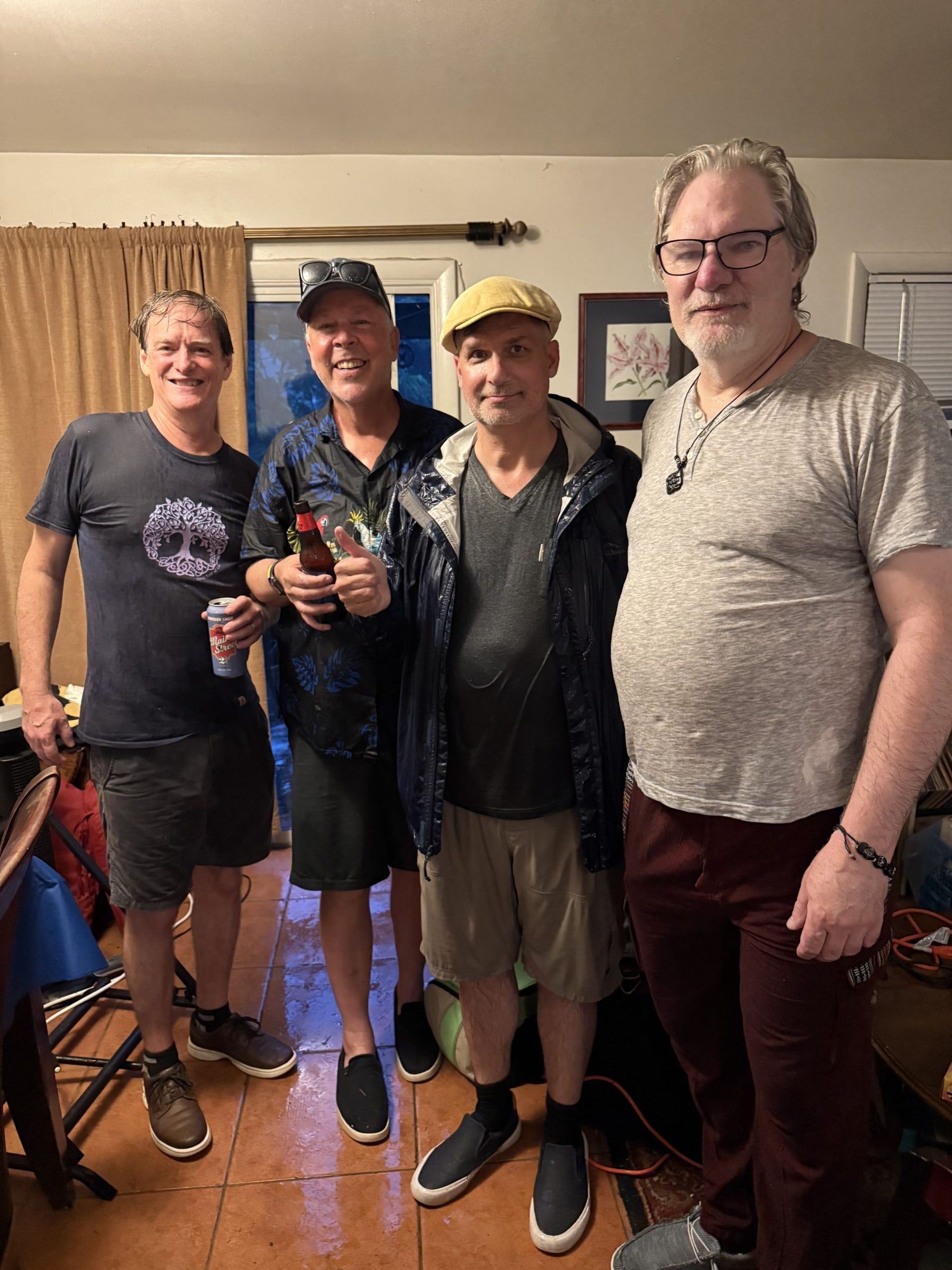 Four members of Microplastic Brain, soaking wet, posing indoors